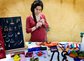 Woman selling jewlery at a craft fair.